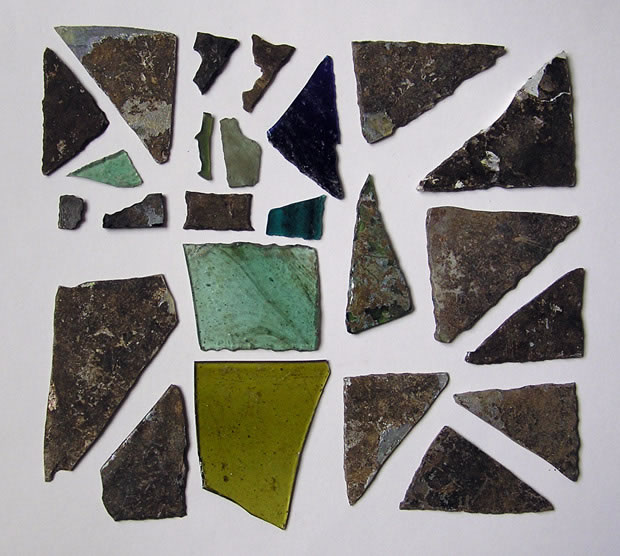 Photographie : Aperçu des teintes que peuvent présenter les vitraux (diverses nuances de vert et de bleu) (crédit L. Pirault / INRAP, 2005)